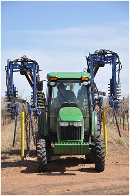 Pre-pruner going through a row of Bingham Family Vineyards vines.