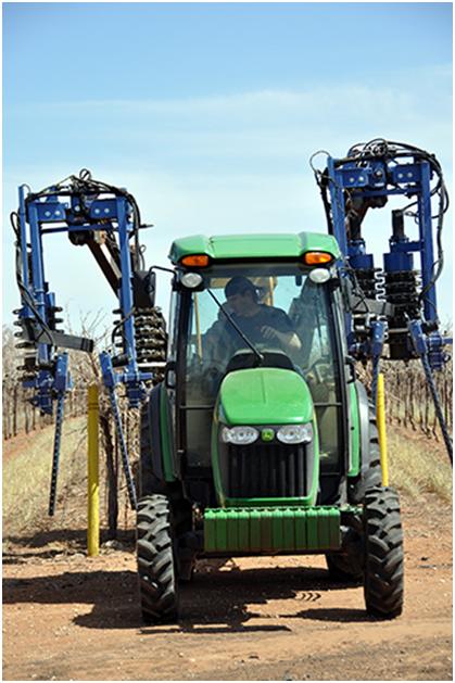 Pre-pruner going through a row of Bingham Family Vineyards vines.