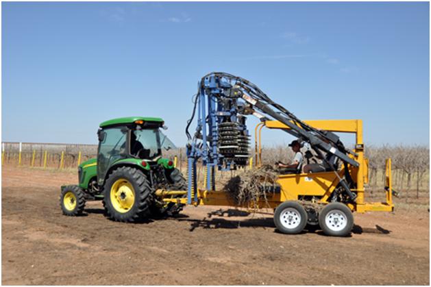 Pre-pruner going through a row of Bingham Family Vineyards vines.