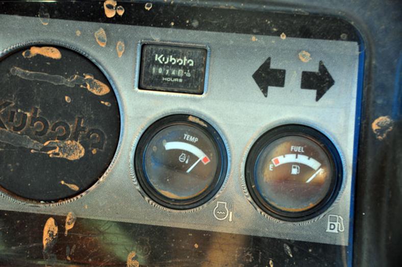 Gauges on dashboard of a Kubota showing it is overheated.